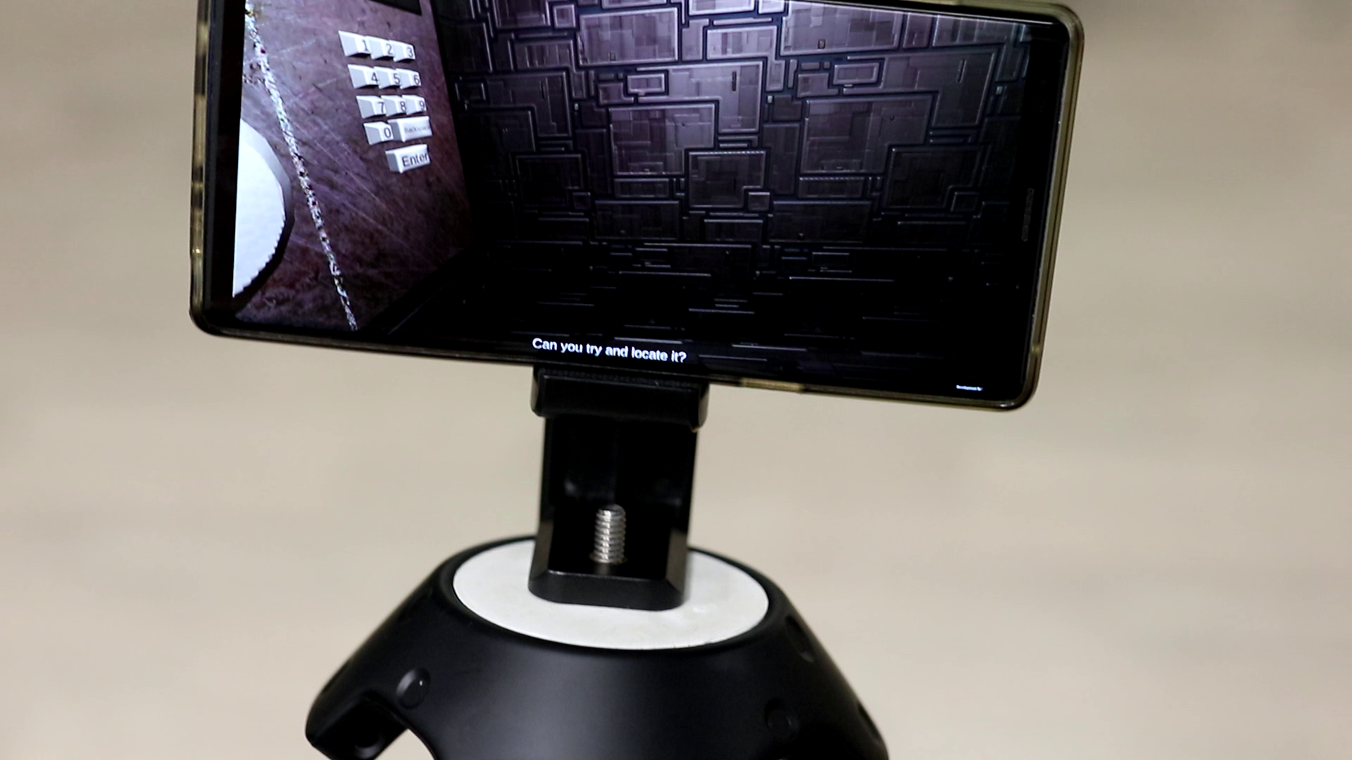 The phone running the game inside the holder